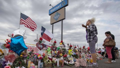 A woman prays at a makeshift memorial for shooting victims at the Cielo Vista Mall Walmart, in El Paso, Texas, on August 6, 2019. - The August 3 shooting left 22 people dead. US President Donald Trump will visit the Texan border city August 7, and will also travel to Dayton, Ohio where a second mass shooting early August 4 left another nine dead. (Photo by Mark RALSTON / AFP) (Photo credit should read MARK RALSTON/AFP/Getty Images)