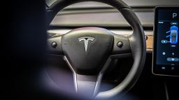 A sits on the steering wheel of a Tesla Inc. Model 3 electric vehicle in the Tesla store in Barcelona, Spain, on Thursday, July 11, 2019. Tesla is poised to increase production at its California car plant and is back in hiring mode, according to an internal email sent days after the company wrapped up a record quarter of deliveries. Photographer: Angel Garcia/Bloomberg via Getty Images