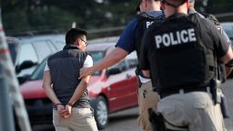 A man is taken into custody at a Koch Foods Inc. plant in Morton, Miss., on Wednesday, Aug. 7, 2019. U.S. immigration officials raided several Mississippi food processing plants on Wednesday and signaled that the early-morning strikes were part of a large-scale operation targeting owners as well as employees.