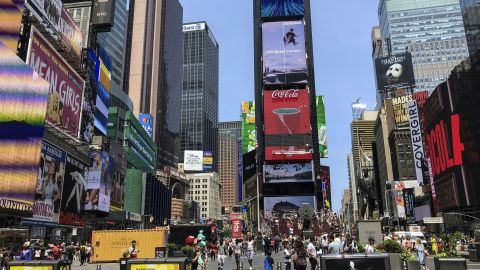 People walk around Times Square in New York City on July 9, 2019. 