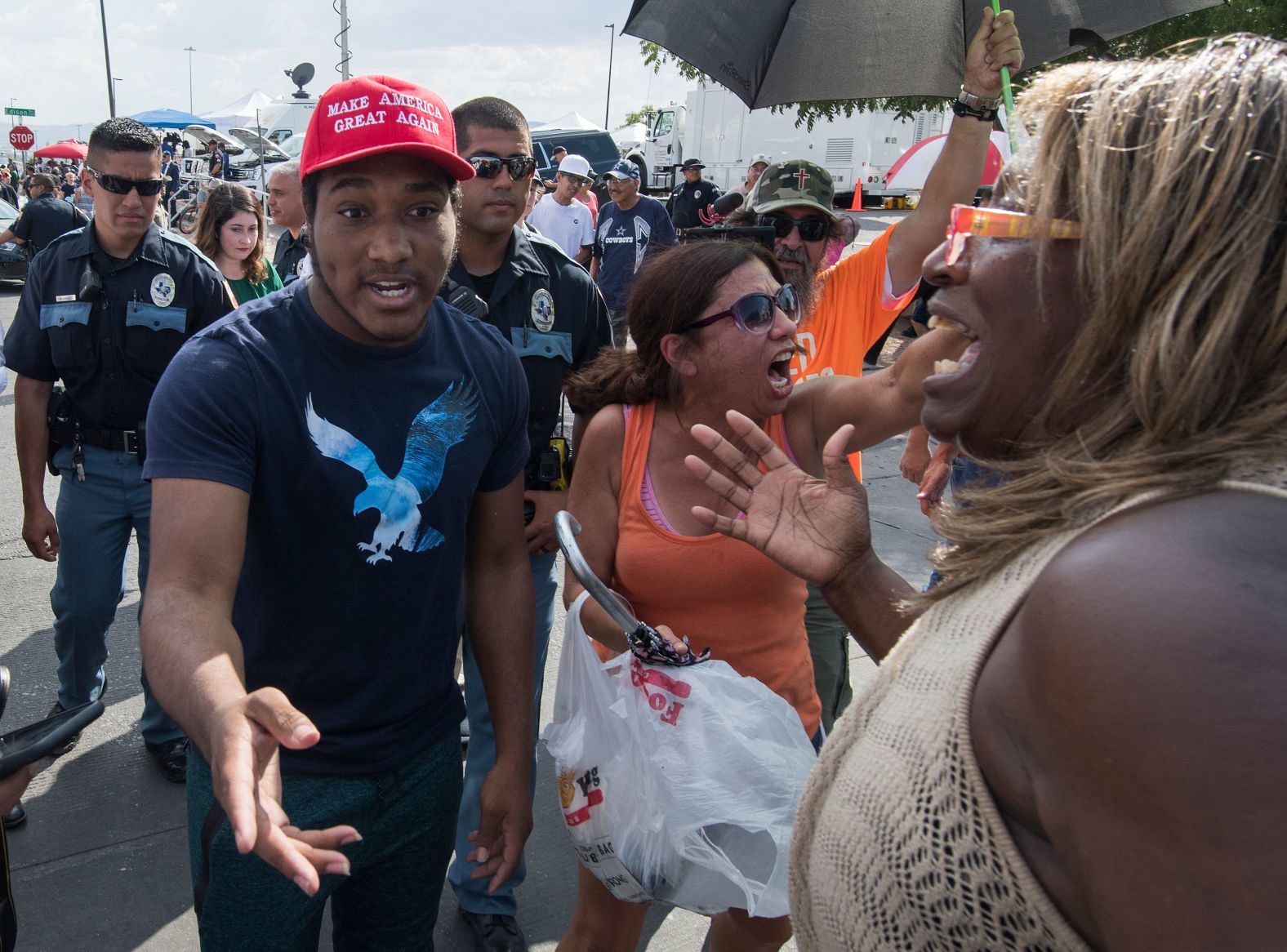 Trump supporters are escorted away by police after clashing with protesters outside the makeshift memorial in El Paso on Wednesday.