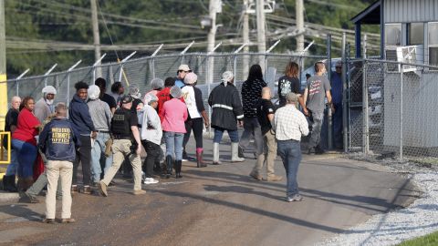 Workers exit a Koch Foods processing plant in Morton after Wednesday's raids.
