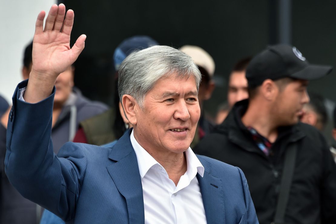 Former Kyrgyzstan's president Almazbek Atambayev waves to his supporters as he attends a rally in Bishkek, on July 3.