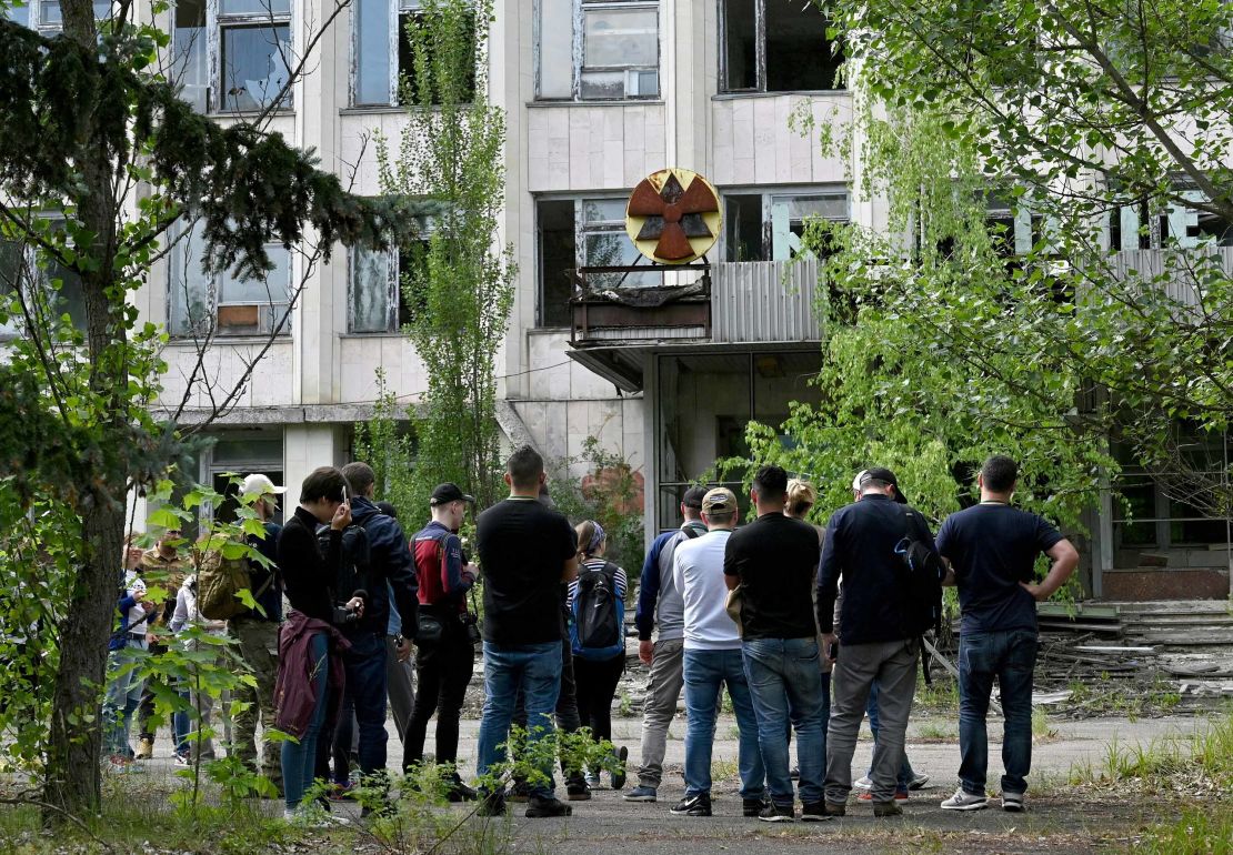 Visitors listen a guide informations in the ghost city of Pripyat during a tour in the Chernobyl exclusion zone. HBOs hugely popular television series Chernobyl has renewed interest in the area.