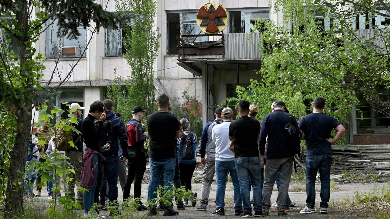 Visitors listen a guide informations in the ghost city of Pripyat during a tour in the Chernobyl exclusion zone. HBOs hugely popular television series Chernobyl has renewed interest in the area.