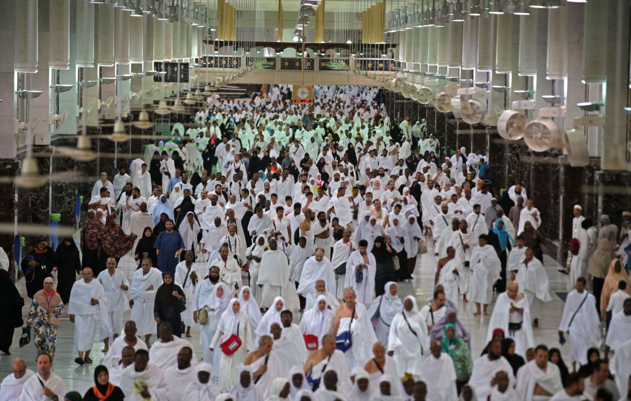 Pilgrims leave after performing morning prayers at the Grand Mosque on Thursday.