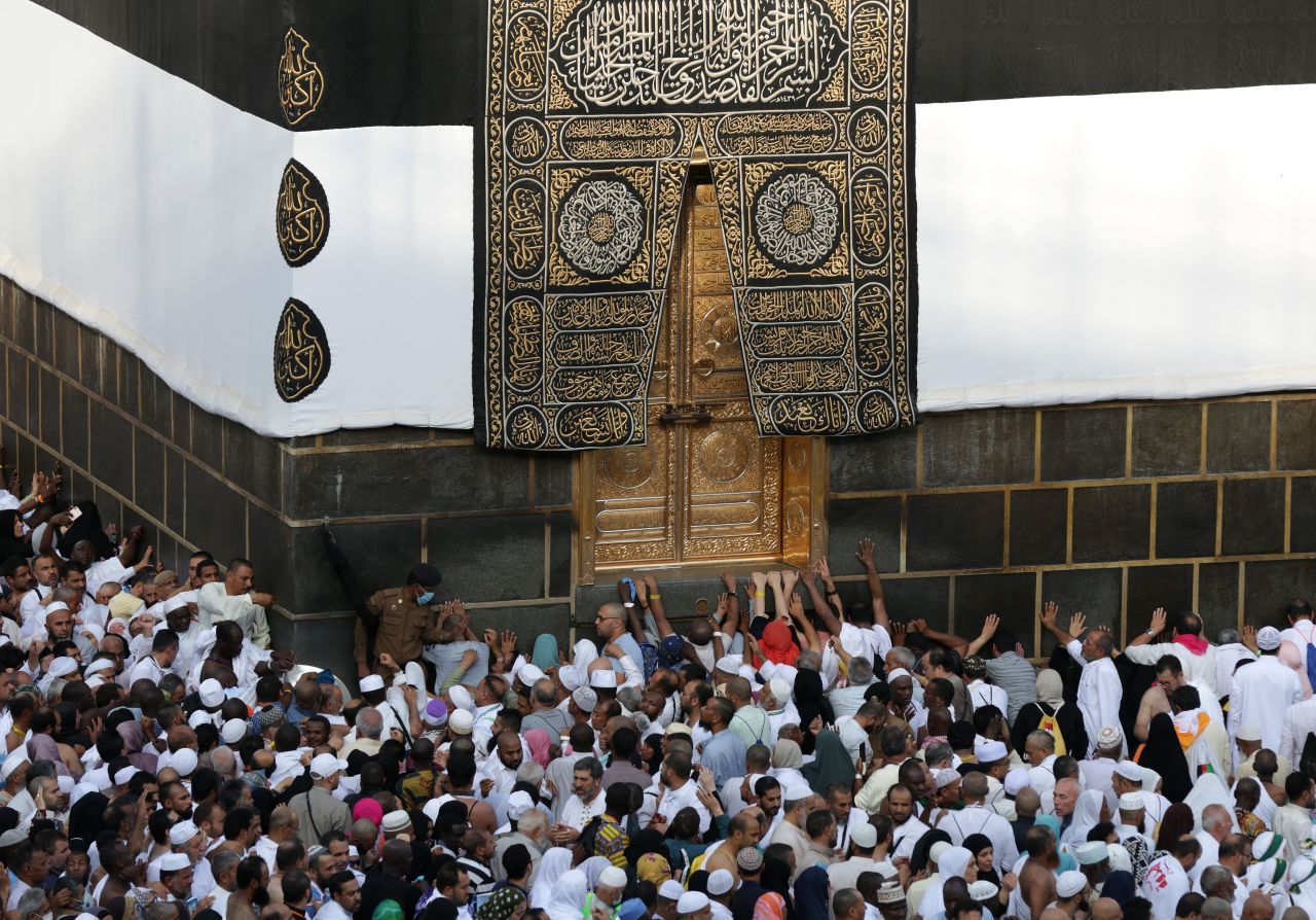 Worshippers touch the golden door of the Kaaba, Islam's holiest shrine.