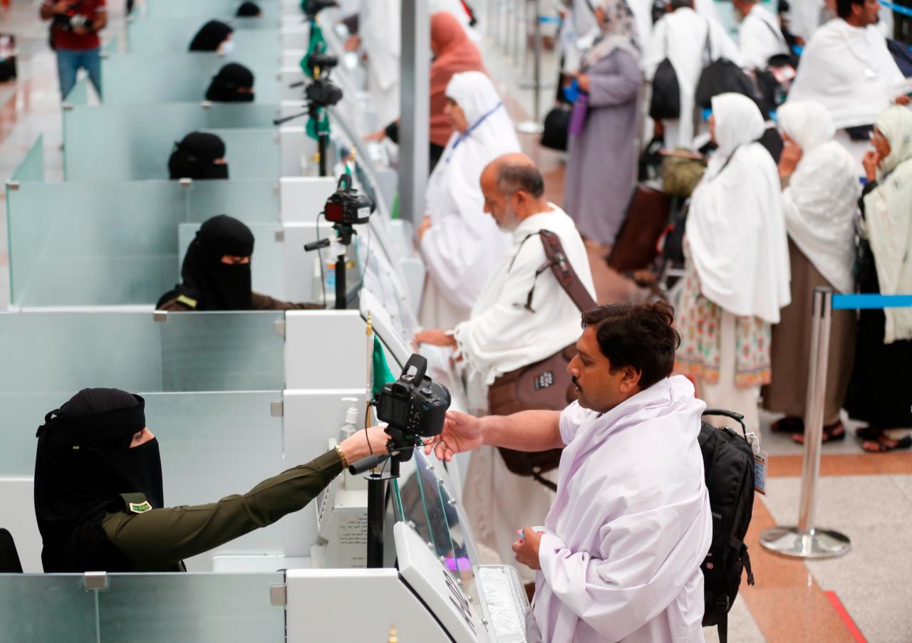 Saudi officers register and check pilgrims at the King Abdulaziz International Airport.