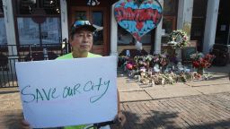 Luong Vo shares a message near a memorial in the Oregon District, where a mass shooting early Sunday morning left nine dead and 27 wounded, on August 07, 2019 in Dayton, Ohio. President Donald Trump visited the city today to offer his support to the community. The shooting happened less than 24 hours after a gunman in Texas opened fire at a shopping mall in El Paso killing 22 people. 