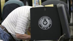 Voters make their choice in the ballot booth during voting in the primary election at Sherrod Elementary school in Arlington, Texas,  Tuesday, March 1, 2016.  (AP Photo/LM Otero)  