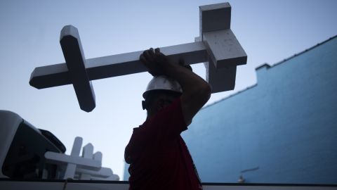 Greg Zanis carries one of the 26,000 crosses he made.