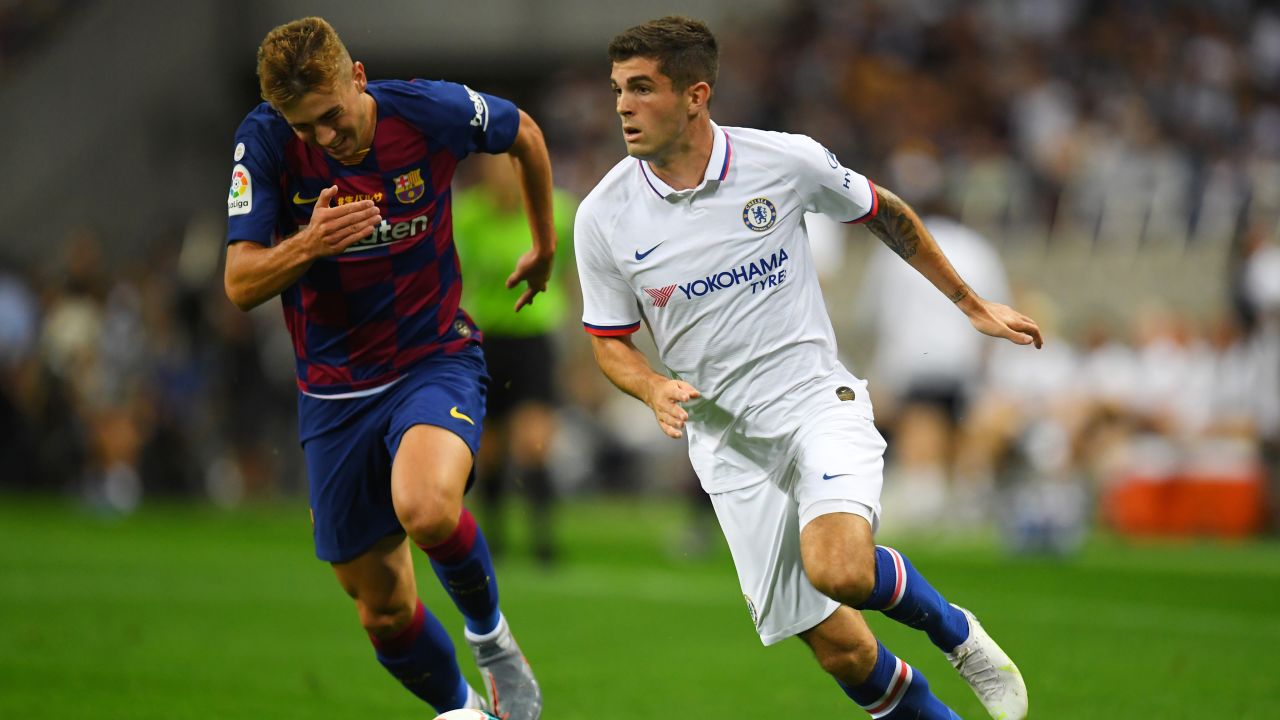 Pulisic runs past Oriol Busquets of Barcelona during their preseason friendly match.