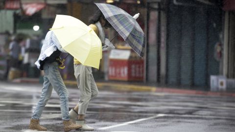 Two Taiwanese women face powerful gusts of wind generated by Typhoon Lekima in Taipei, Taiwan, on August 9, 2019. 