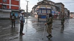 Indian security personnel question a man on a street during a curfew in Srinagar on August 8, 2019, as widespread restrictions on movement and a telecommunications blackout remained in place after the Indian government stripped Jammu and Kashmir of its autonomy. (Photo by Tauseef MUSTAFA / AFP)        (Photo credit should read TAUSEEF MUSTAFA/AFP/Getty Images)