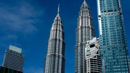 The Petronas Twin Towers, center, stand next to the Menara Maxis building, second right, which houses the country office of Goldman Sachs (Malaysia) Sdn., in Kuala Lumpur, Malaysia, on Tuesday, Dec. 18, 2018. Malaysia is demanding Goldman Sachs Group Inc. bear the brunt of the 1MDB scandal, opening up another legal front for the Wall Street firm over its role raising money for the investment fund. Photographer: Nadirah Zakariya/Bloomberg via Getty Images
