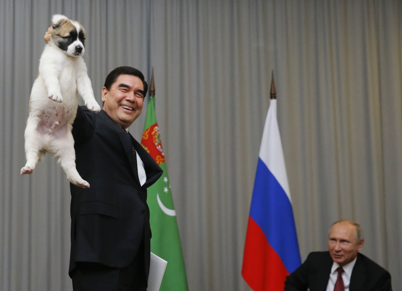 Turkmenistan's President Gurbanguly Berdymukhamedo holds up a puppy he intended to give to Russian President Vladimir Putin in the Black Sea resort of Sochi, Russia, in 2017. 