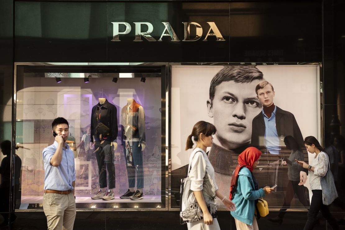 People walk past a Prada store in Hong Kong. The Italian fashion house says sales have been hurt by the protests.