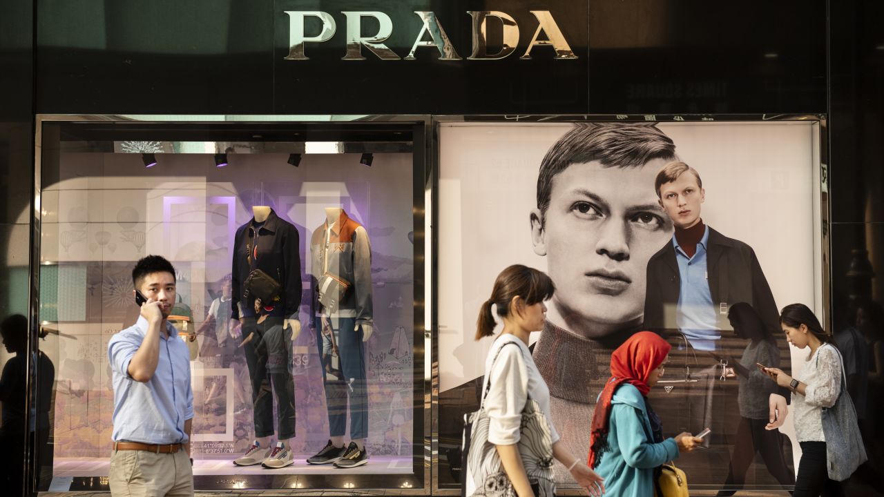 People walk past a Prada store in Hong Kong. The Italian fashion house says sales have been hurt by the protests.
