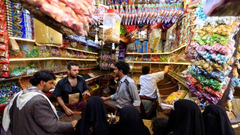 Yemenis buy sweets and nuts at a market in the capital Sanaa on August 8, 2019, as Muslims prepare to celebrate Eid al-Adha.
