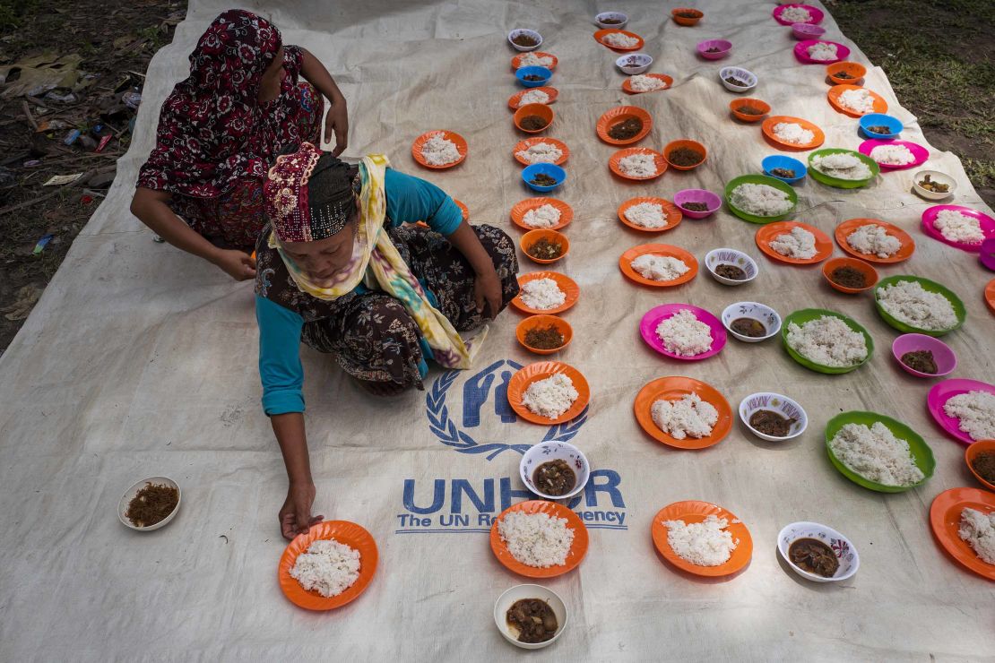 Displaced families in the Philippines prepare food after attending a prayer service to celebrate Eid al-Adha in August 2018.