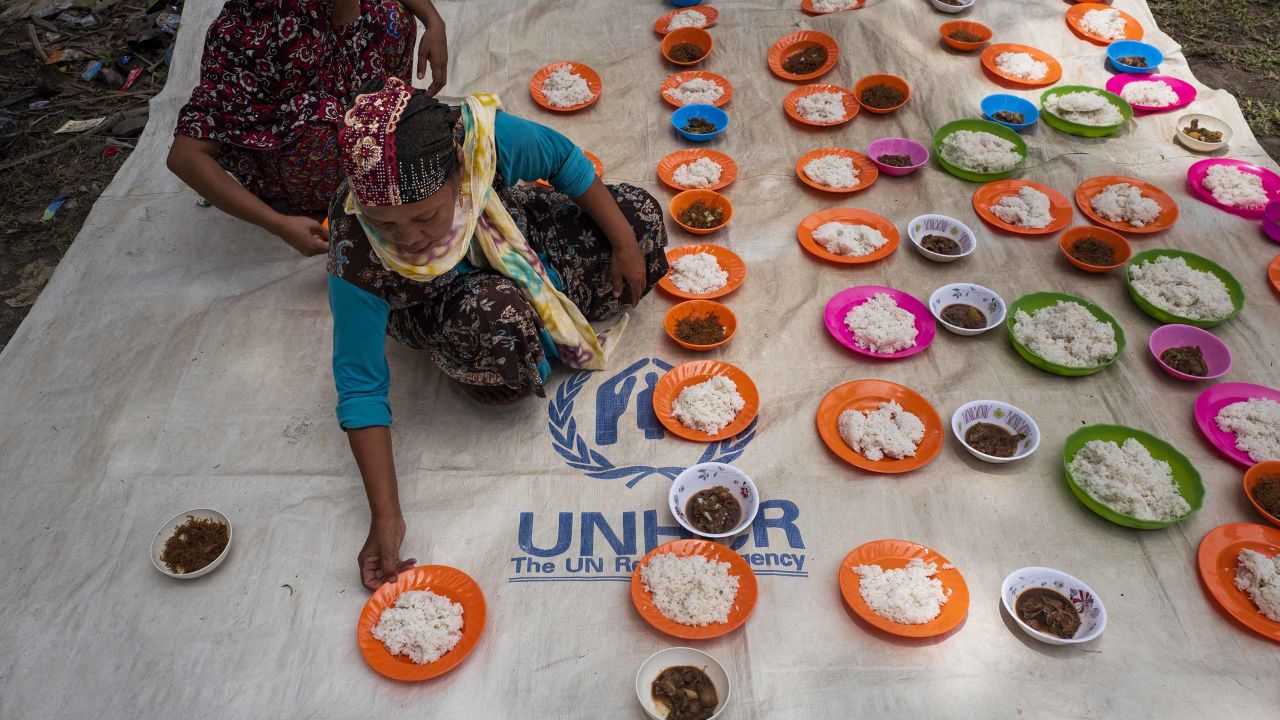 Displaced families in the Philippines prepare food after attending a prayer service to celebrate Eid al-Adha in August 2018.
