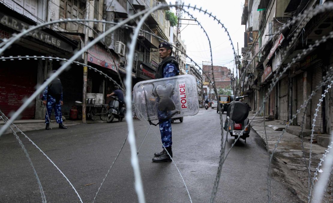 Rapid Action Force personnel stand guard at a roadblock ahead of the Muslim Friday noon prayers in Jammu on August 9, 2019.