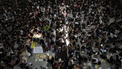 Protesters rally against a controversial extradition bill at Hong Kongs international airport on August 9, 2019. - Hundreds of pro-democracy activists, some wearing face masks and helmets, staged a sit-in at Hong Kong's airport on August 9 hoping to win support from international visitors for their movement. (Photo by Anthony WALLACE / AFP)        (Photo credit should read ANTHONY WALLACE/AFP/Getty Images)