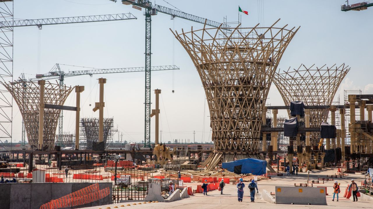 Workers walk through the construction site of the main terminal at the cancelled New International Airport of Mexico City (NAICM) in Texcoco, Mexico.