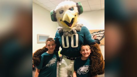 Twins Jack and Ryan Ykoruk, who have autism, play with Swoop, the Philadelphia Eagles mascot.