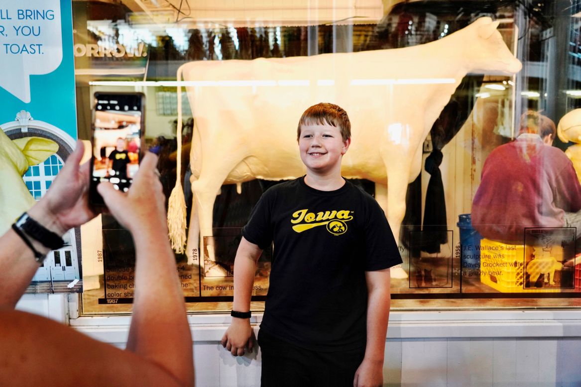 A boy poses in front of the Iowa State Fair's famous butter cow on Friday, August 9. Since 1911, <a href="http://www.cnn.com/2019/08/09/politics/gallery/iowa-state-fair-2019/index.html" target="_blank">the fair</a> has had a cow sculpted out of butter. Each year, much of the butter is recycled. It can be reused for up to 10 years. 