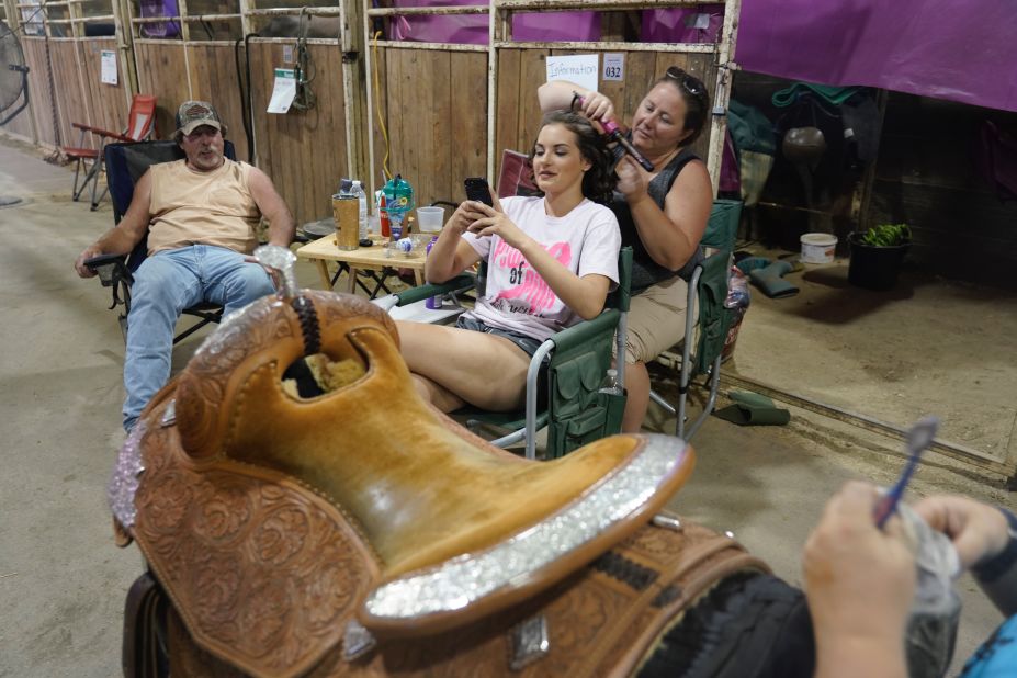 A young woman has her hair done for the Cowgirl Queen Contest.