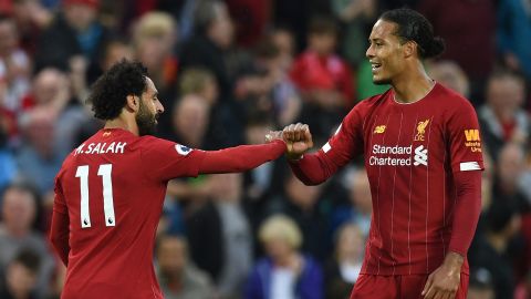 Mohamed Salah (L) celebrates with Liverpool's Dutch defender Virgil van Dijk after scoring the team's second goal against Norwich.
