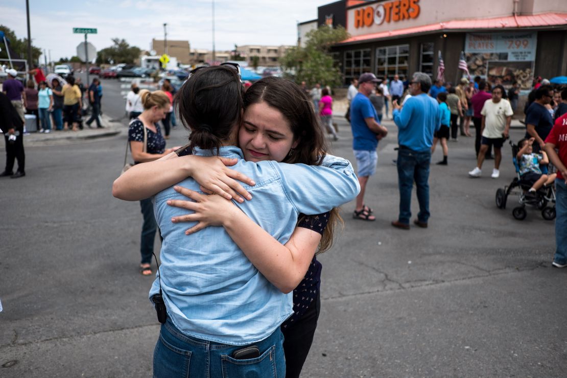 CNN reporter Nicole Chavez hugs Adria Gonzalez, a survivor of the mass shooting in El Paso, across from the Walmart where the shooting took place. 