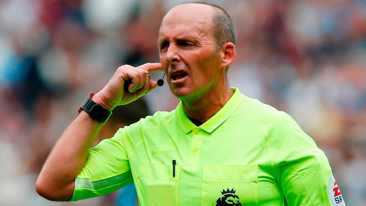 Referee Mike Dean consults the video assistant referee