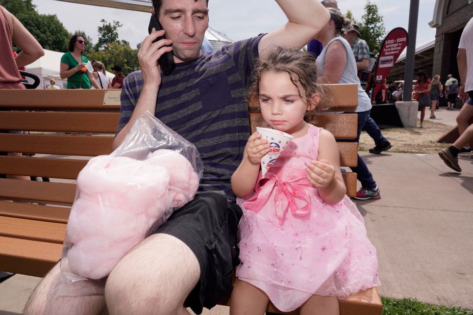 A girl cools off with a snow cone.