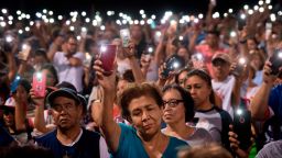 TOPSHOT - People hold up their phones during a prayer and candle vigil organized by the city, after a shooting left 20 people dead at the Cielo Vista Mall Wal-Mart in El Paso, Texas, on August 4, 2019. - A shooting at a Walmart store in Texas left multiple people dead. At least one suspect was taken into custody after the shooting in the border city of El Paso, triggering fear and panic among weekend shoppers as well as widespread condemnation. It was the second fatal shooting in less than a week at a Walmart store in the US and comes after a mass shooting in California last weekend. (Photo by Mark RALSTON / AFP)        (Photo credit should read MARK RALSTON/AFP/Getty Images)