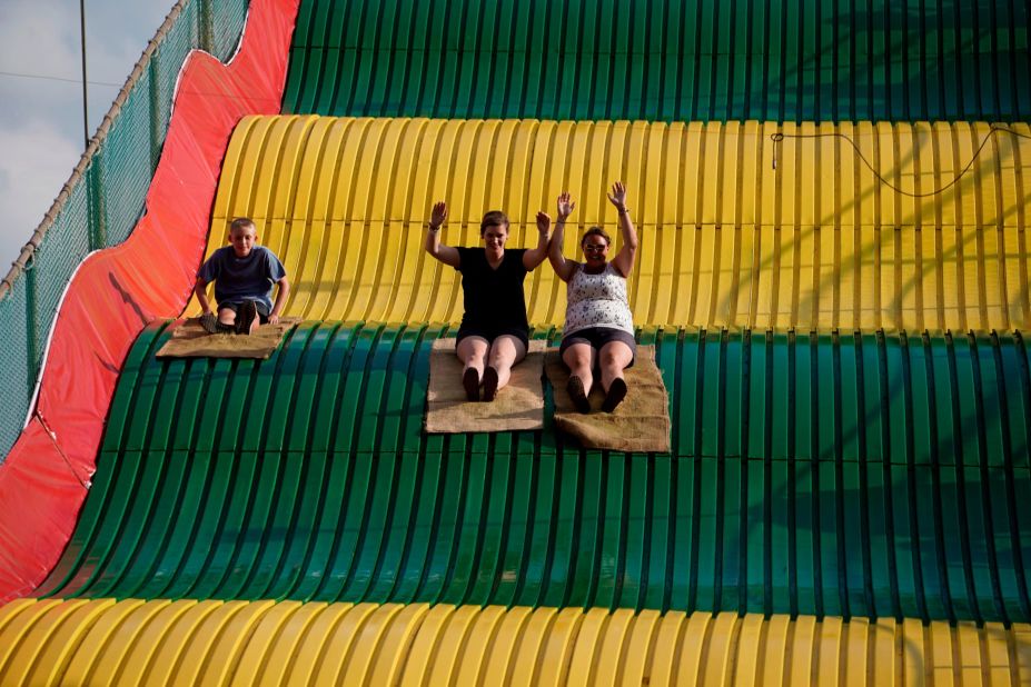 People enjoy a large slide at the fair.