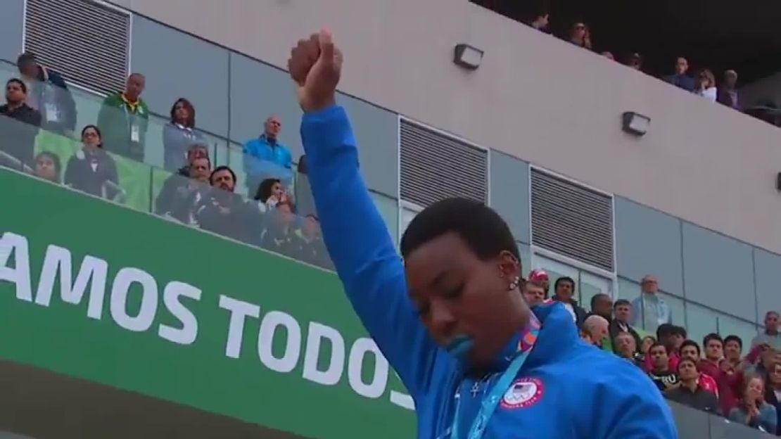 U.S. hammer thrower Gwen Berry raises her fist at the end of the national anthem at the Pan Am Games. 