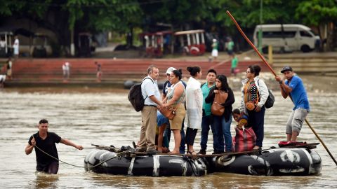 Guatemalan migrants use a makeshift raft to cross the Suchiate River from Guatemala to Mexico.