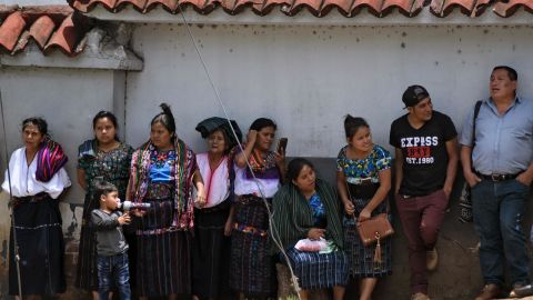 Guatemalan migrants deported from the US standing outside an Air Force base after arriving in Guatemala City.