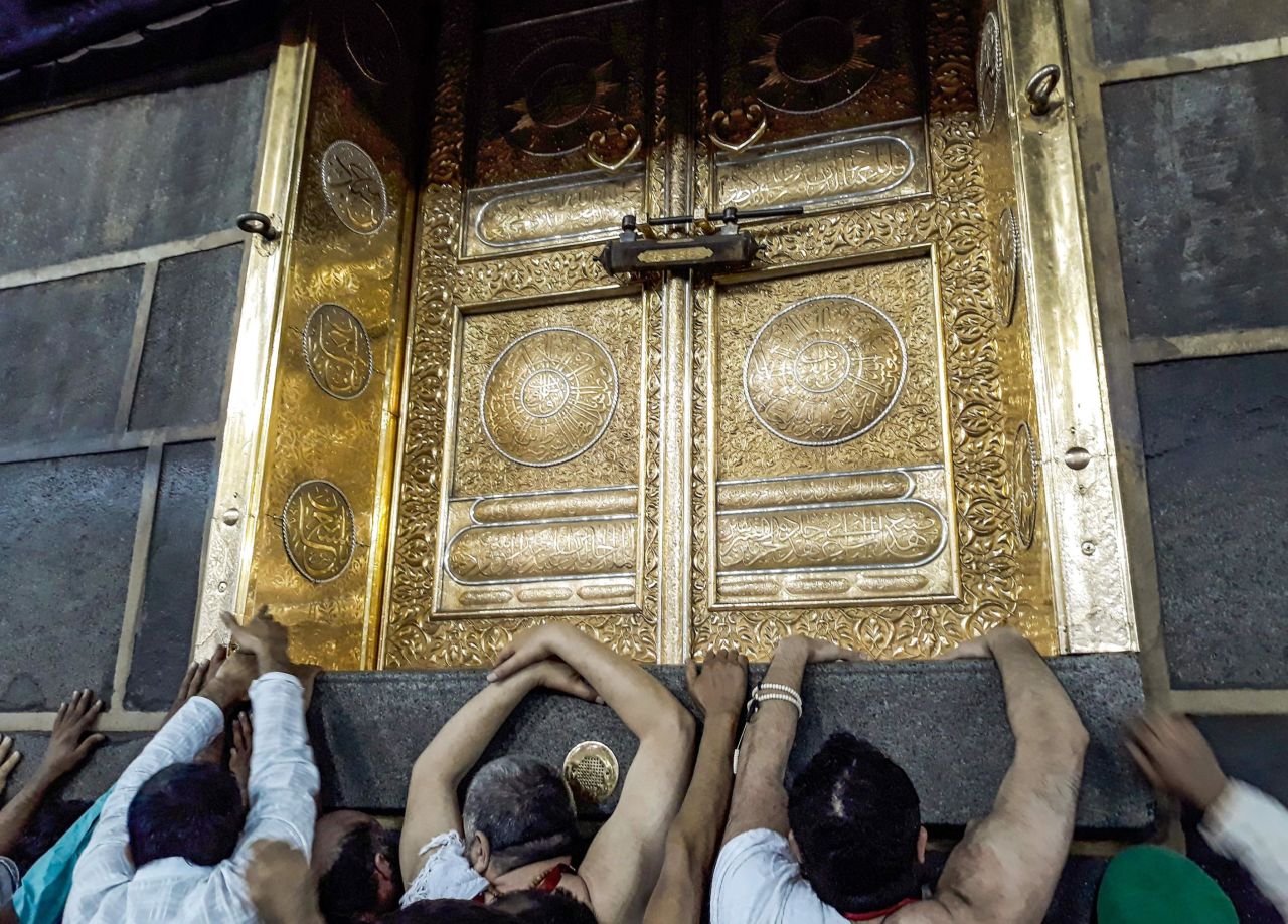 Muslims pilgrims gather outside the door of the Kaaba, Islam's holiest shrine, on Sunday, August 11.