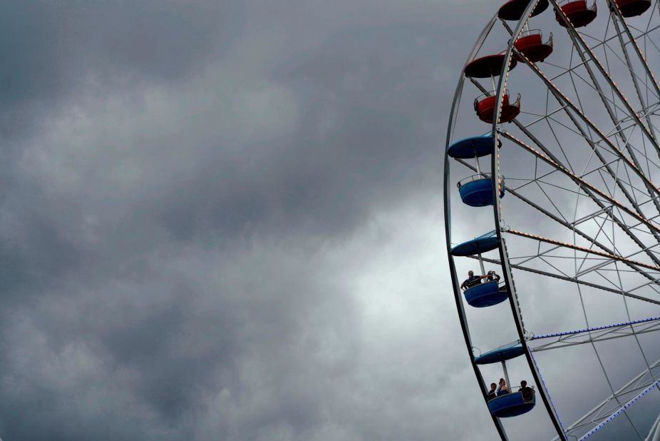 Dark clouds loom over the Ferris wheel on Sunday.