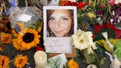 Flowers, candles and chalk-written messages surround a photograph of Heather Heyer on the spot where she was killed and 19 others injured when a car slamed into a crowd of people protesting against a white supremacist rally in August 2017.