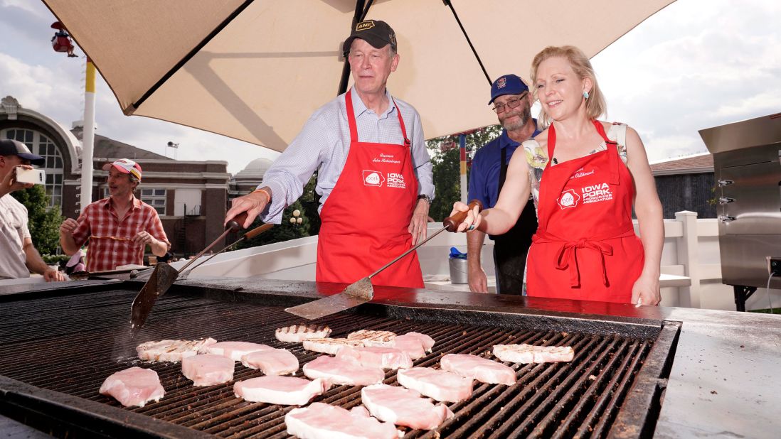 Democratic presidential candidates John Hickenlooper and Kirsten Gillibrand flip pork chops at the Iowa State Fair on Saturday, August 10. Iowa is the top pork-producing state in the United States.