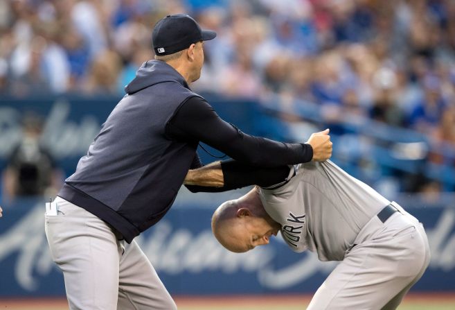 New York Yankees manager Aaron Boone holds Brett Gardner from going after umpire Chris Segal during a Major League Baseball game in Toronto on Friday, August 9. <a href="https://ftw.usatoday.com/2019/08/yankees-brett-gardner-gets-ejected-while-sitting-quietly-erupts-on-umpire" target="_blank" target="_blank">Gardner was angry</a> because Segal had thrown him out of the game.