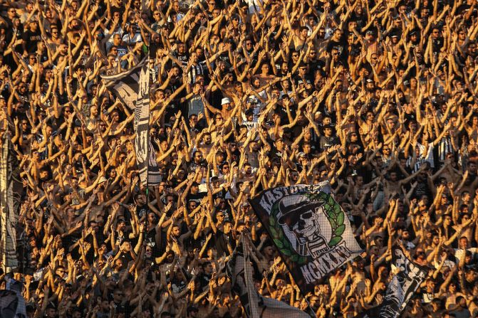 Fans of Greek soccer club PAOK chant slogans during a Champions League qualifier in Thessaloniki, Greece, on Tuesday, August 6.