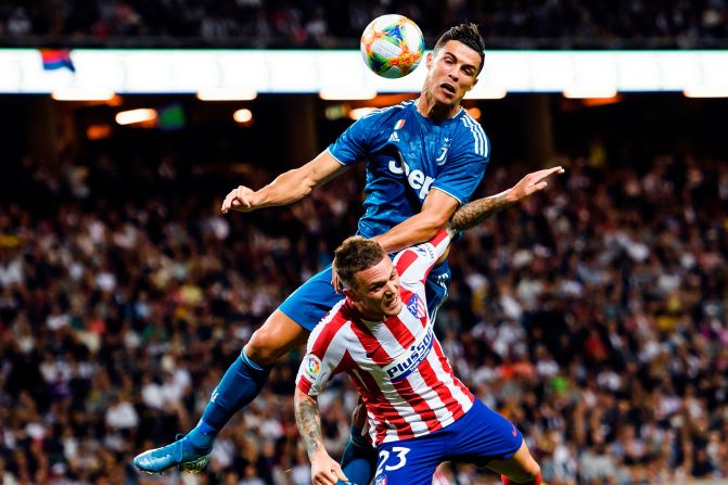 Juventus' Cristiano Ronaldo heads the ball over Atletico Madrid's Kieran Trippier during a preseason match in Solna, Sweden, on Saturday, August 10.