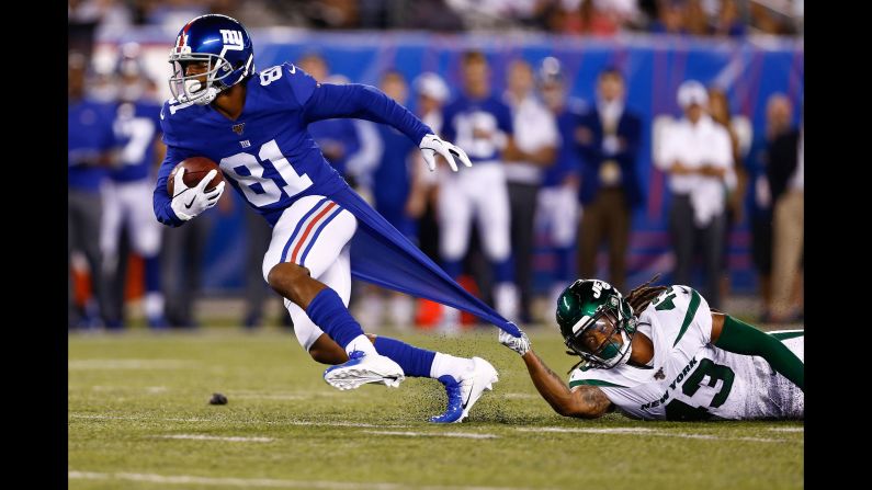 New York Jets cornerback Parry Nickerson tries to corral New York Giants wide receiver Russell Shepard during an NFL preseason game on Thursday, August 8. Shepard scored a touchdown on the play.