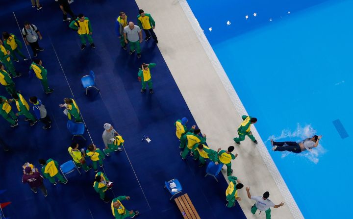 Brazilian swimmers toss a team member into the empty diving pool at the end of the Pan American Games swimming competition on Saturday, August 10.