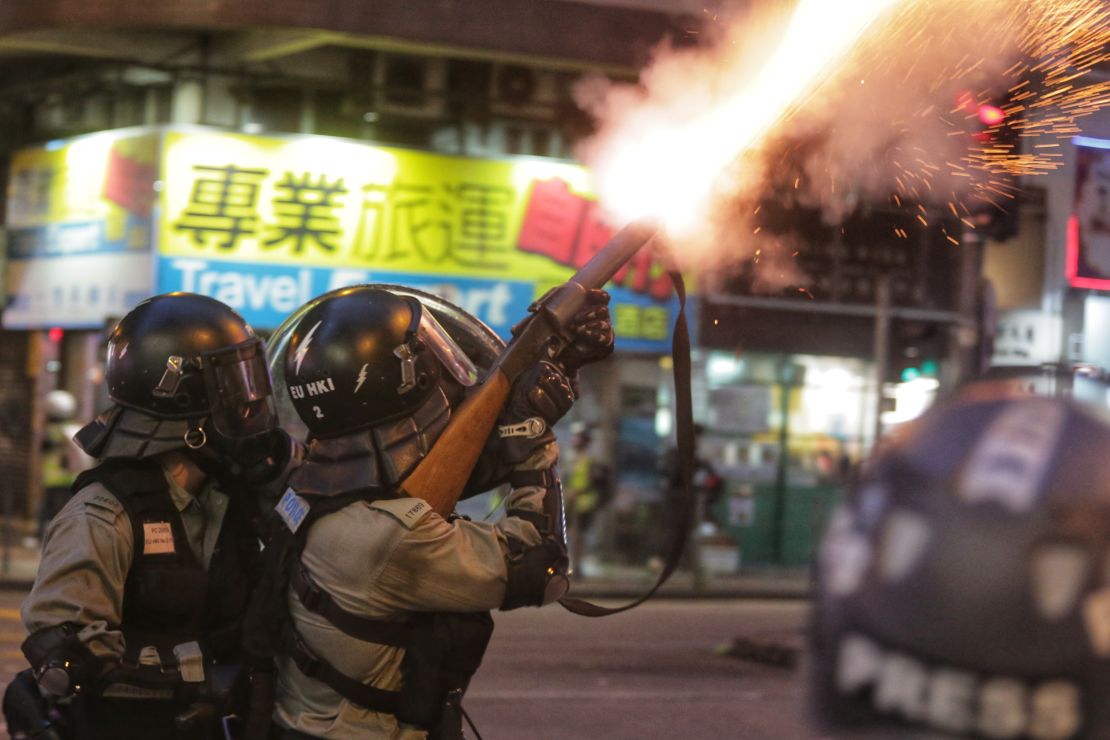 Riot police fire tear gas towards pro-democracy protesters during a stand-off in the Wan Chai district in Hong Kong on August 11, 2019. 